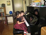 Alice playing piano with Ally